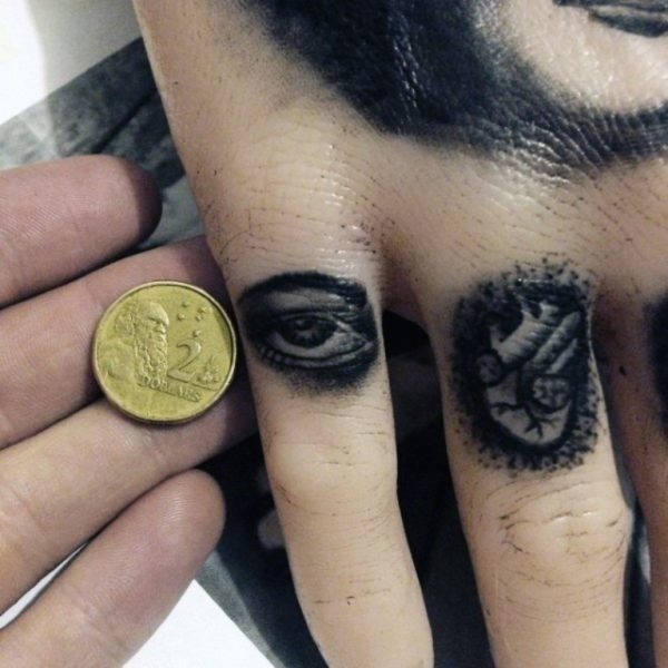 Black Eye Tattoo On Finger