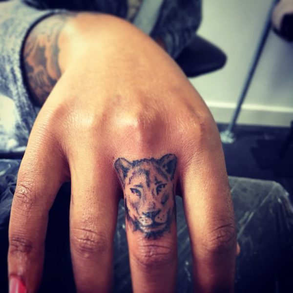 Small Lioness Finger Tattoo