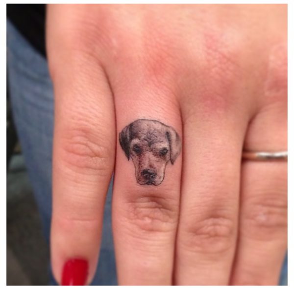 Adorable Dog Tattoo On Ring Finger
