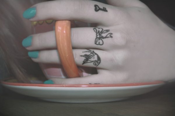 Attractive Bow Tattoo On Middle Finger
