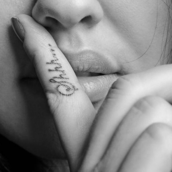  Black And White Shhh Tattoo On Finger
