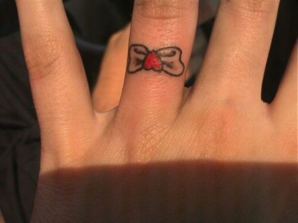 Black Bow Tattoo On Ring Finger