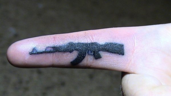 Black Gun Tattoo On Finger