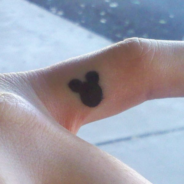 Black Mickey Mouse Tattoo On Finger