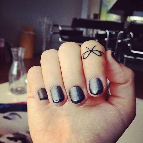 Bow Tattoo On First Finger