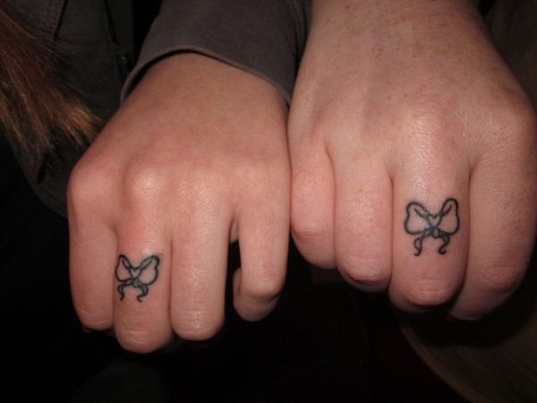 Bows Tattoo On Middle Finger