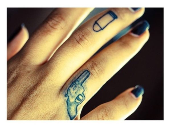 Bullet And Gun Finger Tattoo On Finger