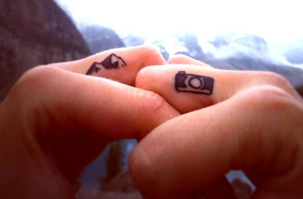 Camera Tattoo On Middle Finger
