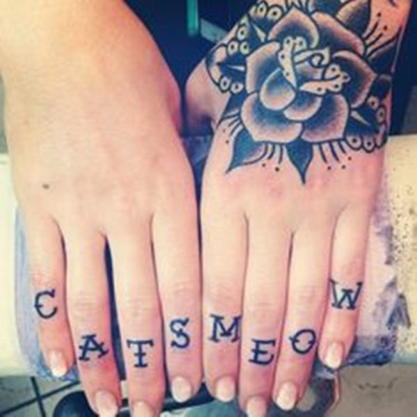 Cats Lettering Tattoo On Finger