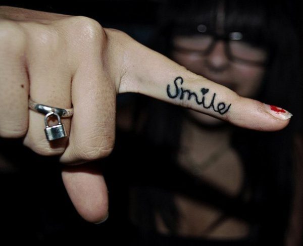 Dazzling Smile Tattoo On Finger