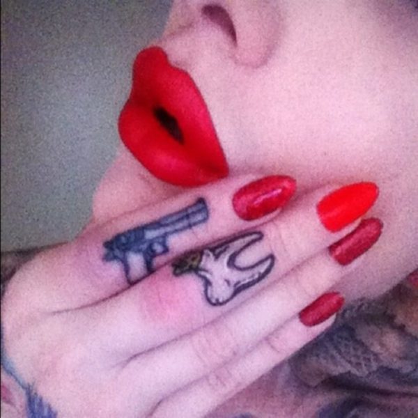 Impressive Gun Tattoo On Finger