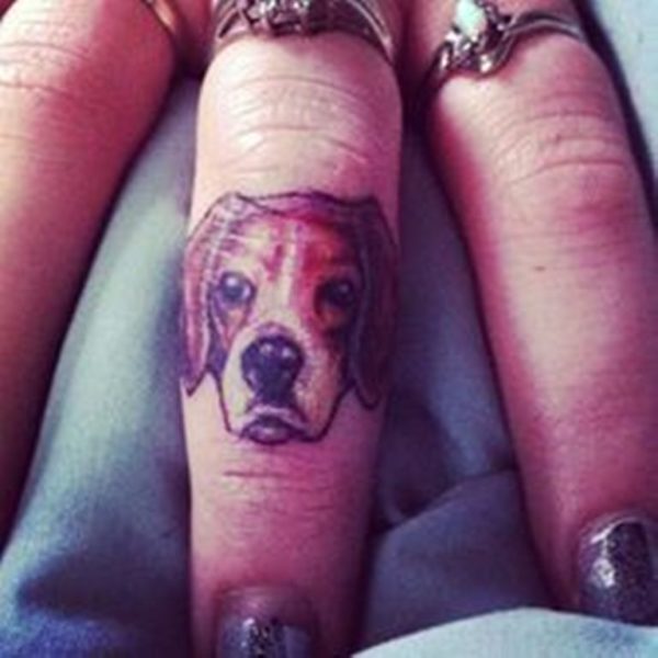 Nice Dog Face Tattoo On Middle Finger