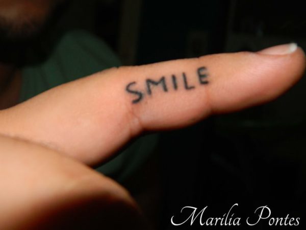Nice Smile Tattoo Design On Finger