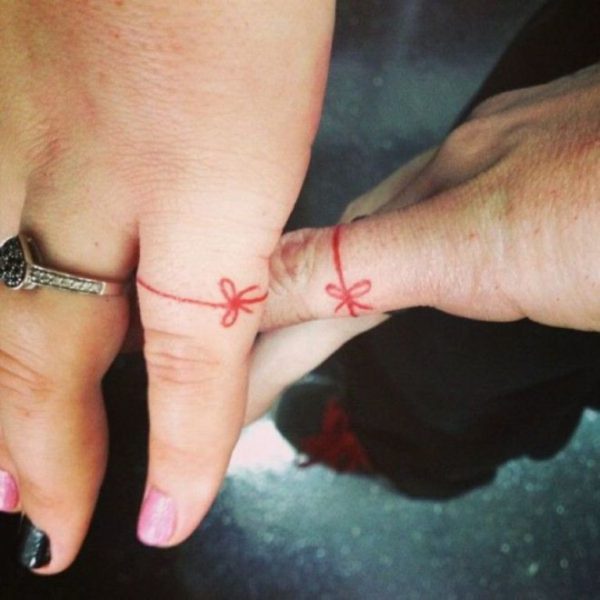 Nice Red Bow Tattoo On Little Finger