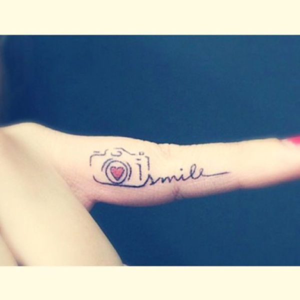 Smile Camera Tattoo On Finger