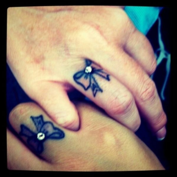 Stunning Bow Tattoo On Fingers