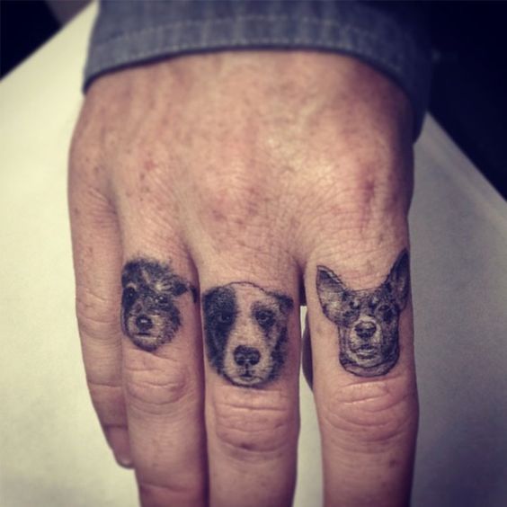 Three Adorable Dogs Tattoo On Finger