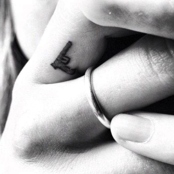 Tiny Gun Tattoo On Finger