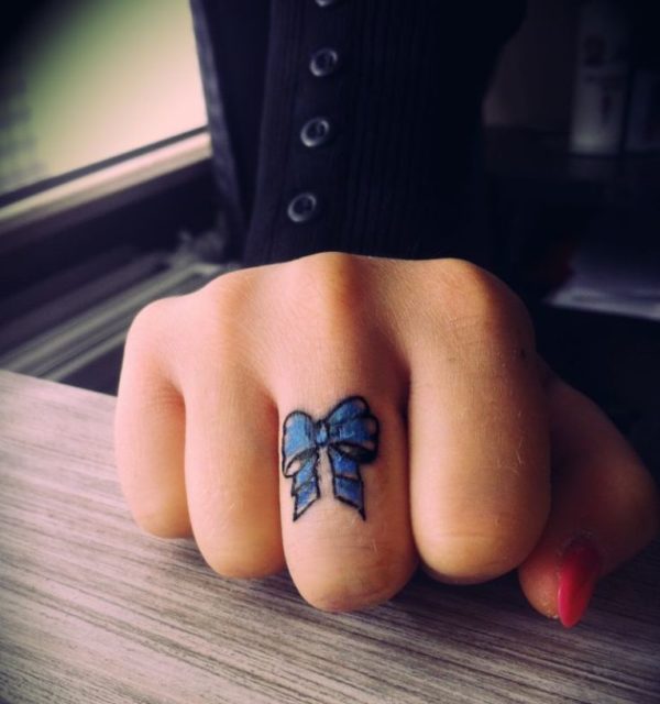 Wonderful Blue Bow Tattoo On Middle Finger